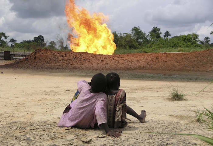 Shell flare at Rumuekpe showing kids sitting in close proximity to the flare, easily accessible to anyone in the village.